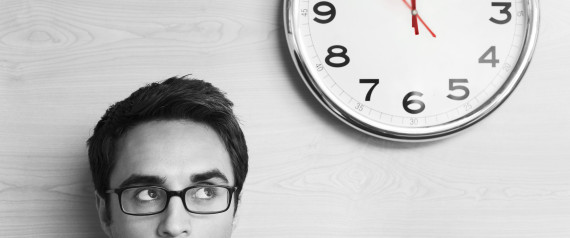 Anxious Businessman Looking at Office Clock