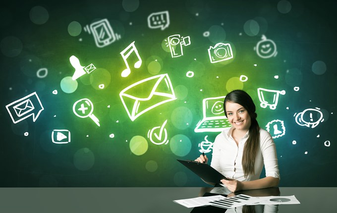 Businesswoman sitting at the black table with social media symbols on the background